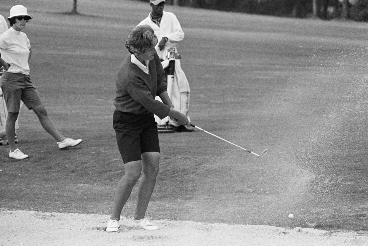 FILE - Kathy Whitworth of San Antonio, blast out of sand trap on 18th green and then sinks a 6-foot putt to go into the lead of the Women Titleholders Golf Tournament at Augusta, Ga., Nov. 25, 1966. Former LPGA Tour player Whitworth, whose 88 victories are the most by any golfer on a single professional tour, died on Saturday, Dec. 25, 2022, night, her longtime partner said. She was 83. (AP Photo/Horace Cort, File)