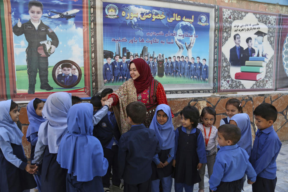 In this Sunday, Oct. 14, 2018 photo, Hameeda Danesh, a candidate for Parliament, hoping to represent the deeply conservative district of Jalrez in central Wardak province, visits a school, in Kabul, Afghanistan. In Saturday’s election 417, or roughly 16 percent, of the 2,565 candidates competing for seats in the 249-member chamber are women. Yet in rural Afghanistan, especially in the country’s ethnic Pashtun areas where the Taliban dominate, many women are not even registered to vote. (AP Photo/Rahmat Gul)