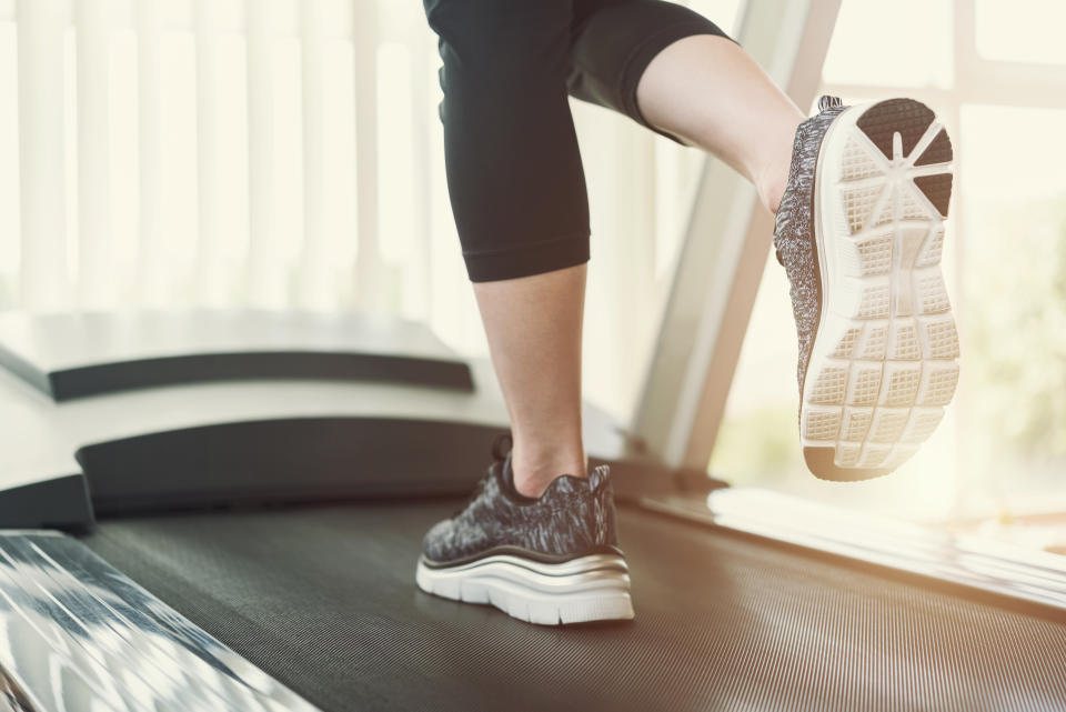 Low Section Of Woman Running On Treadmill