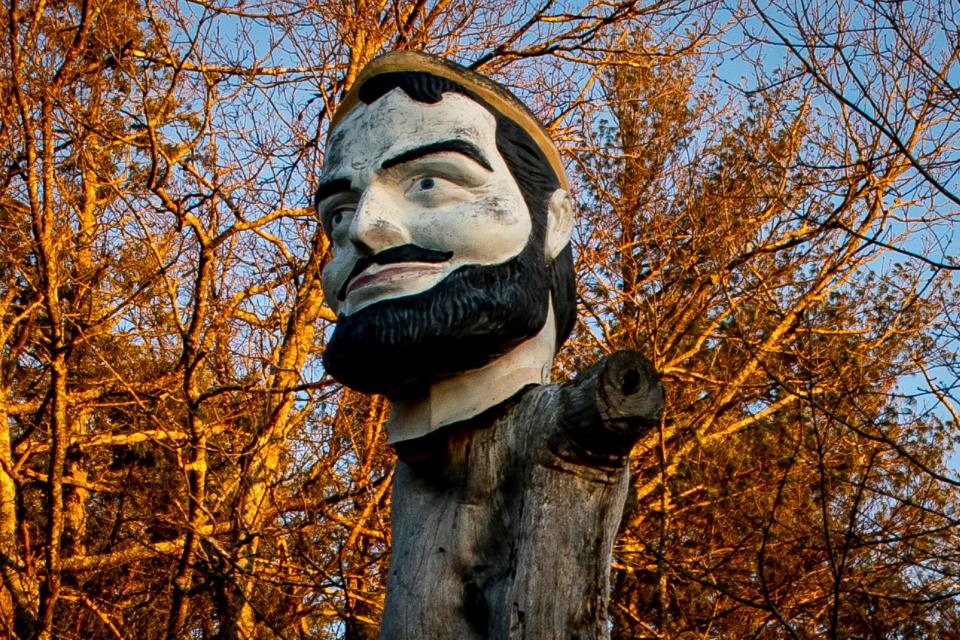 The head of a Paul Bunyan statue sits atop a tree on Birch Hill Road in York, Maine on April 26, 2021.