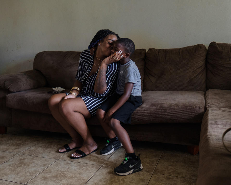 Smith kisses her son in their living room.  (Stephanie Mei-Ling for NBC News and ProPublica)