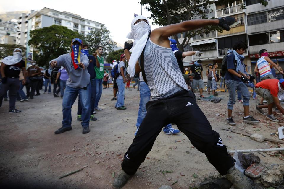 Anti-government protesters throws stones at the police during clashes at Altamira square in Caracas March 3, 2014. Jailed Venezuelan opposition leader Leopoldo Lopez urged sympathizers on Monday to maintain street protests against President Nicolas Maduro as the country's foreign minister prepared to meet the United Nations Secretary General. REUTERS/Jorge Silva