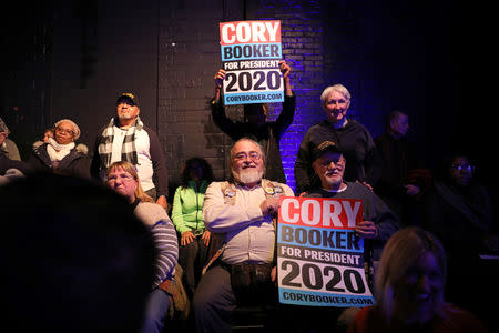 Supports hold signs in support of U.S. Senator Cory Booker (D-NJ) as he speaks during his 2020 U.S. presidential campaign in Des Moines, Iowa, U.S., February 9, 2019. REUTERS/Scott Morgan