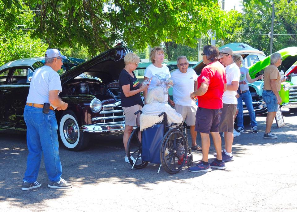 Visitors and Wayne County Care Center residents spend time admiring cars and motorcycles during the Classic Car and Bike Show. The event, sponsored by the care center, raised money for field trips for residents.