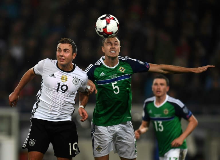 Germany's striker Mario Goetze (L) and Northern Ireland´s Jonny Evans vie for the ball during the WC 2018 football qualification match between Germany and Northern Ireland on October 11, 2016