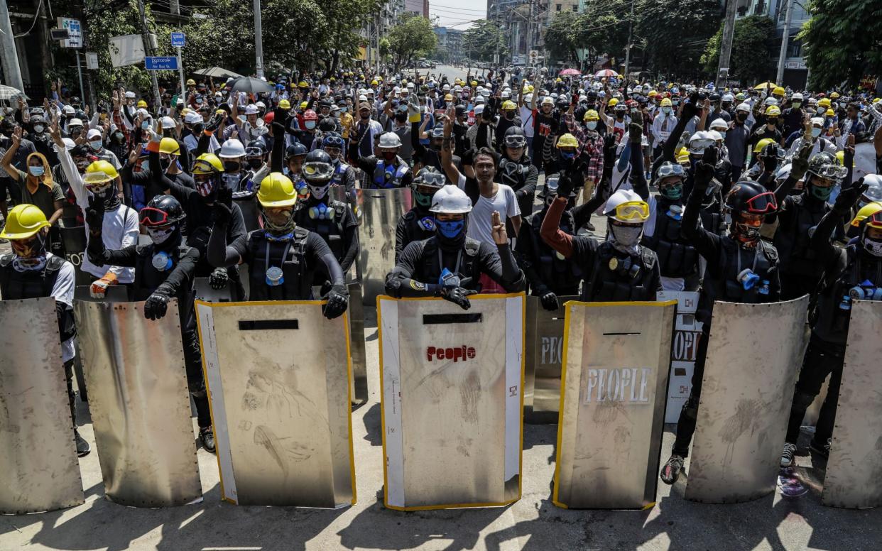 Demonstrators flash the three-finger salute during a protest in Yangon on Monday - LYNN BO BO/EPA-EFE/Shutterstock 