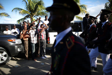 Residents take pictures as members of the Haitian Armed Forces (FAD'H) parade in the streets of Cap-Haitien, Haiti, November 18, 2017. REUTERS/Andres Martinez Casares