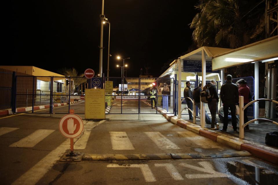 Foreigners wait to cross to Egypt at the Israeli side of the Taba crossing near the Red Sea resort of Eilat, Sunday, Feb 16, 2014. An explosion ripped through a tourist bus Sunday near a border crossing between Egypt and Israel, killing at least three South Koreans and an Egyptian driver in an attack that stoked fears Sinai militants have resumed a bloody campaign against tourists. The targeting of foreign tourists was the first in the area in nearly a decade. (AP Photo/Tsafrir Abayov)