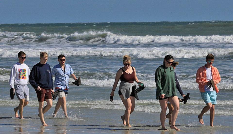 Spring break visitors stroll the sand in Daytona Beach. Despite the annual influx of families and students, bed-tax collections for the Halifax Area Advertising Authority that encompasses Daytona's beachside were down year-over-year by 2.32% in March, according to county records.