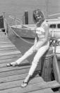 <p>Goldie Hawn gives the camera a smile while resting on the pillar of a dock. The actress looks ready for a summer day in a white ruffle tank top and white jeans. </p>