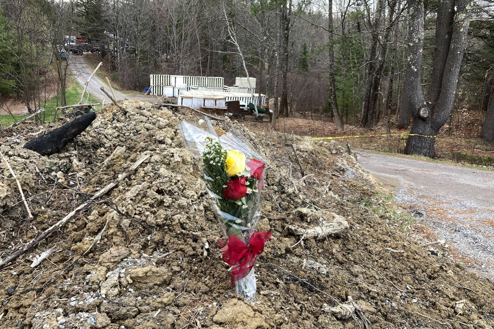A lone bouquet of flowers marks a desolate makeshift memorial at the end of a driveway at a Bowdoin, Maine, home, Wednesday, April 19, 2023, where police say four people were killed. A Maine man who police say killed four people in a home and then shot three others randomly on a busy highway had been released days earlier from prison, a state official said Wednesday. (AP Photo/Rodrique Ngowi)
