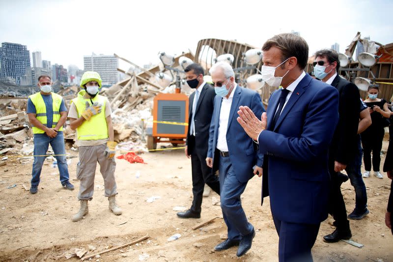 French President Emmanuel Macron gestures as he arrives at the devastated site of the explosion at the port of Beirut