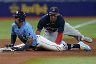 Tampa Bay Rays' Wander Franco, left, slides in safely to third base ahead of the tag by Boston Red Sox's Rafael Devers during the sixth inning of a baseball game Wednesday, June 23, 2021, in St. Petersburg, Fla. Franco went from first base to third on a single by Austin Meadows. (AP Photo/Chris O'Meara)