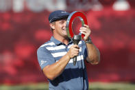 Bryson DeChambeau holds the Rocket Mortgage Classic golf tournament trophy Sunday, July 5, 2020, at Detroit Golf Club in Detroit. DeChambeau won the tournament. (AP Photo/Carlos Osorio)