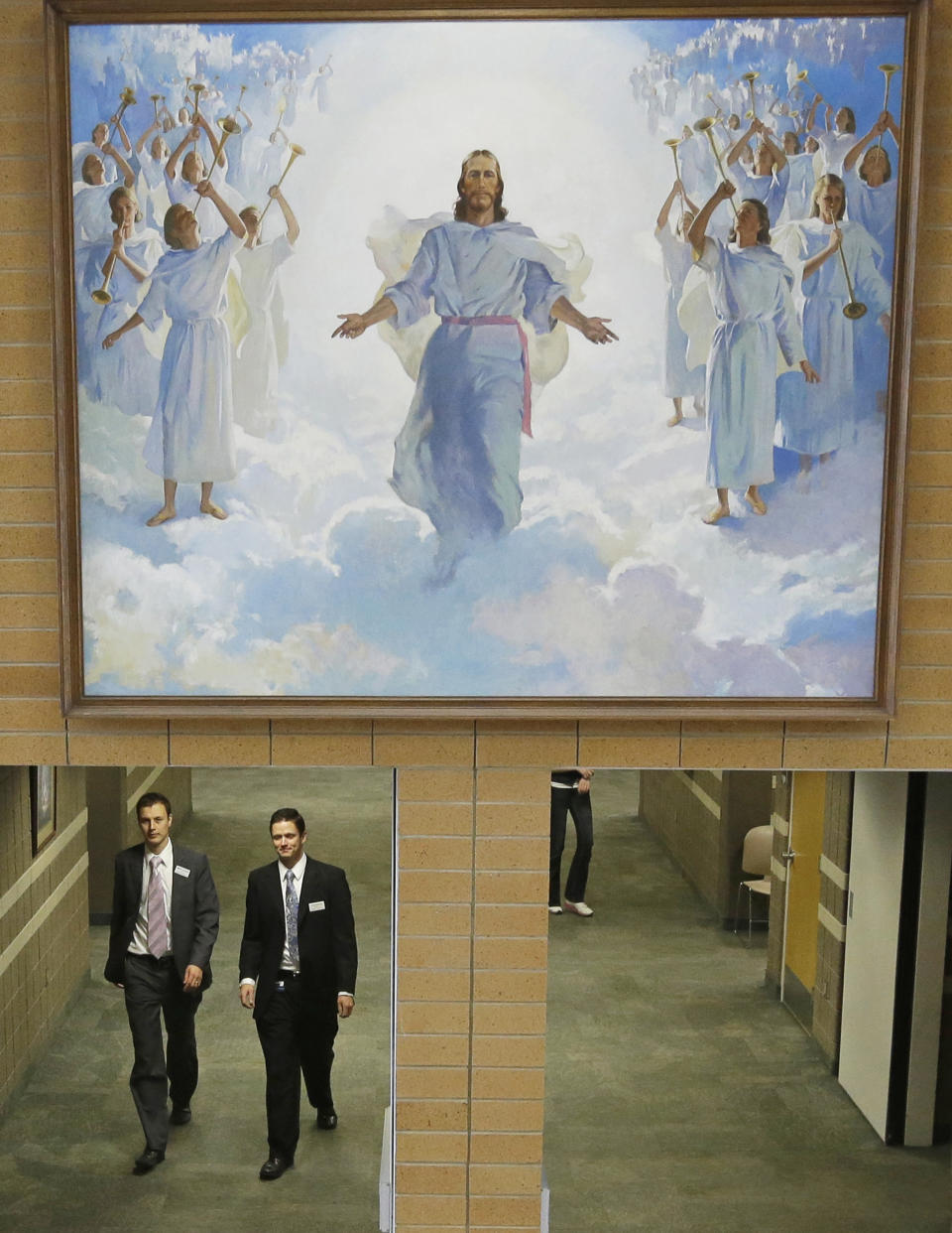 FILE - In this Jan. 8, 2013, file photo, people walk through the halls at the Missionary Training Center in Provo, Utah. Parents of Mormon missionaries will be able to hear their children's voices a lot more often under new rules announced Friday, Feb. 15, 2019, that allow the proselytizing youngsters to call home every week instead of only twice a year. (AP Photo/Rick Bowmer, File)