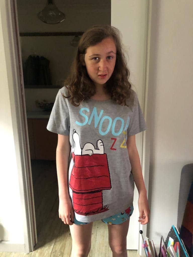 A file photo of Nora Quoirin in a grey Snoopy T-shirt shirt.