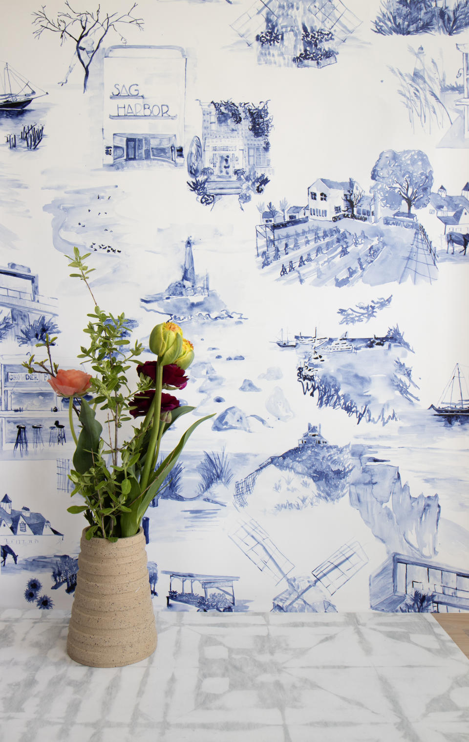 This undated photo shows New York-based textile design studio Eskayel's new pattern called Out East. Founder Shanan Campanaro's watercolor toile paintings were drawn from photos of the Hamptons sourced through interior design firm Curious Yellow. Montauk landmarks like the lighthouse and clam bar, Sag Harbor's windmill and theater, and Sagaponack's vineyards and stables are among the charming images. (Eskayel via AP)