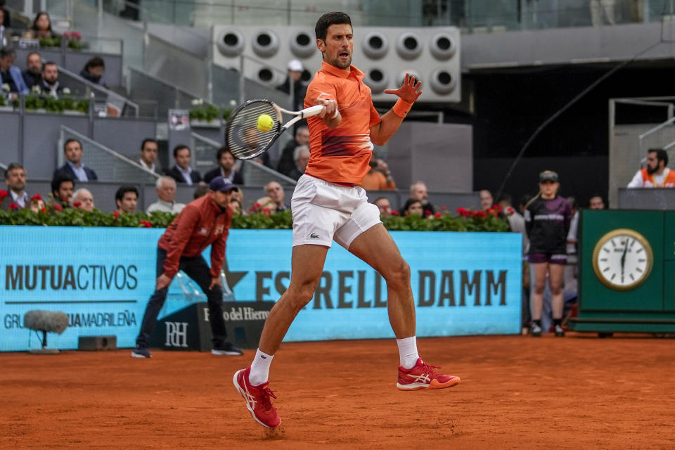 Serbia's Novak Djokovic returns the ball against Gael Monfils, of France, during their match at the Mutua Madrid Open tennis tournament in Madrid, Spain, Tuesday, May 3, 2022. (AP Photo/Manu Fernandez)