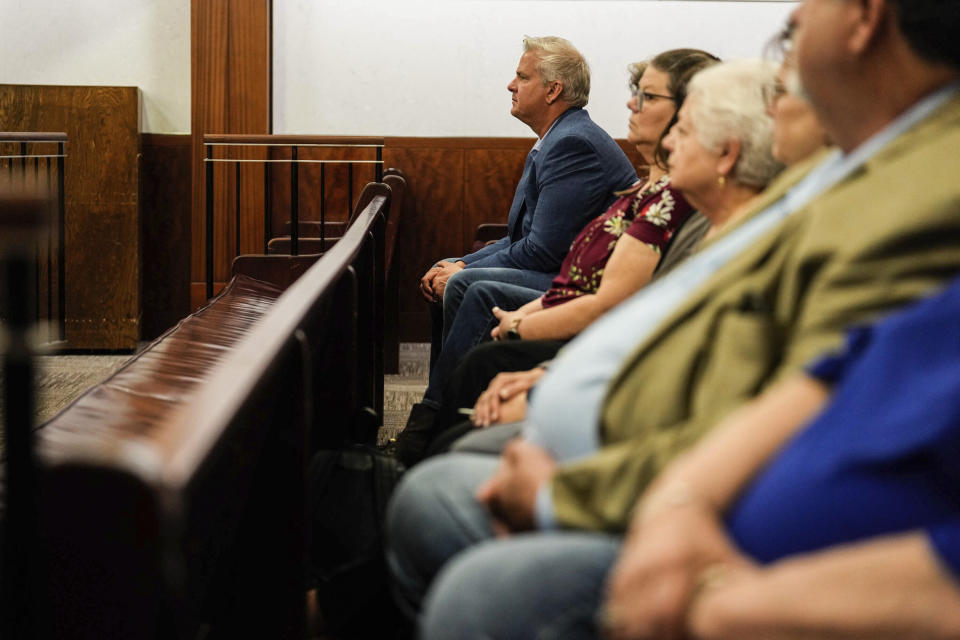 Darren Temple, brother of David Temple, left, sits beside family and friends during the sentencing trial for David Temple in the Harris County 178th District Criminal Court Monday, April 10, 2023 in Houston. David Temple was convicted for the second time for the murder of his pregnant wife, Belinda Lucas Temple, in Aug. 2019, but the sentencing was postponed due to the COVID-19 pandemic. (Raquel Natalicchio/Houston Chronicle via AP)