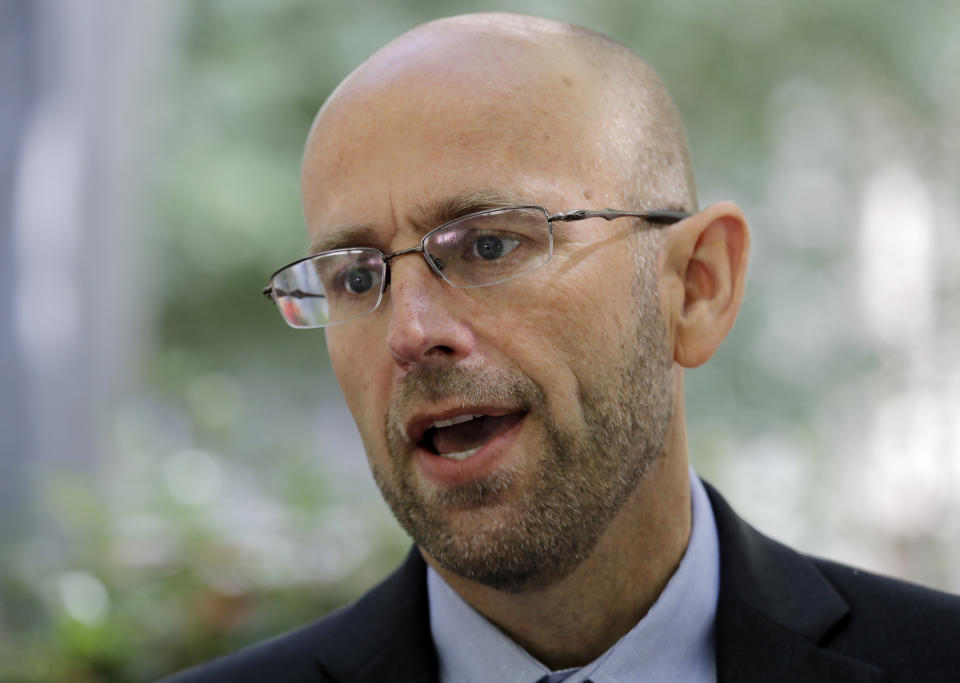 Matt Adams, Legal Director of the Northwest Immigrant Rights Project, speaks with media members following a hearing on asylum seekers at the U.S. Courthouse Friday, June 28, 2019, in Seattle. A federal judge heard a challenge to a new Trump administration policy, scheduled to take effect next month, that would keep thousands of asylum seekers locked up while they pursue their cases, instead of allowing them to be released on bond. It targets immigrants who have recently entered the U.S. without permission and have demonstrated a credible fear of persecution or torture if returned to their home country. (AP Photo/Elaine Thompson)