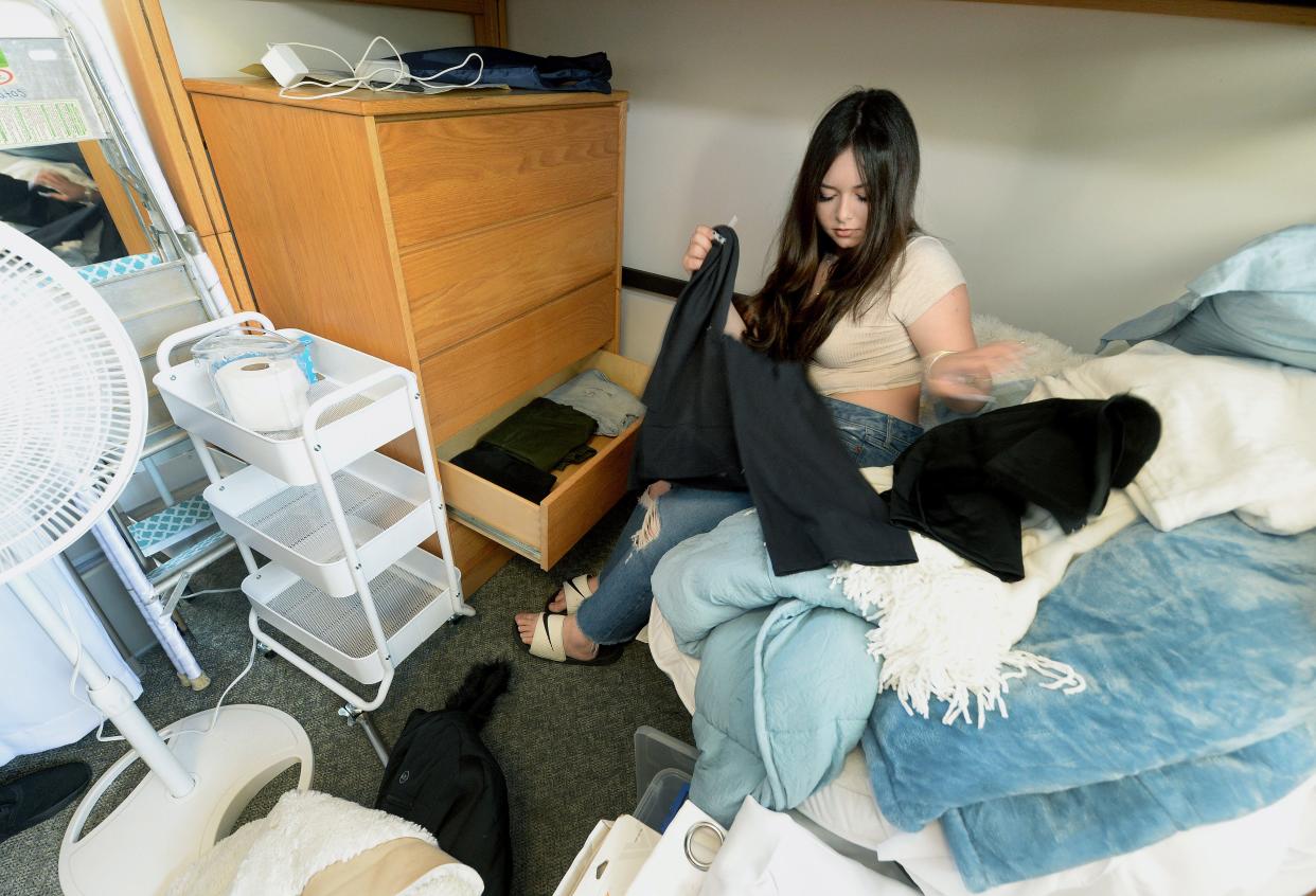 Freshman Solimar Matos, of Chicago,  puts away her things after moving into her dorm room at Lincoln Hall at the University of Illinois Springfield Tuesday, August 22, 2023.