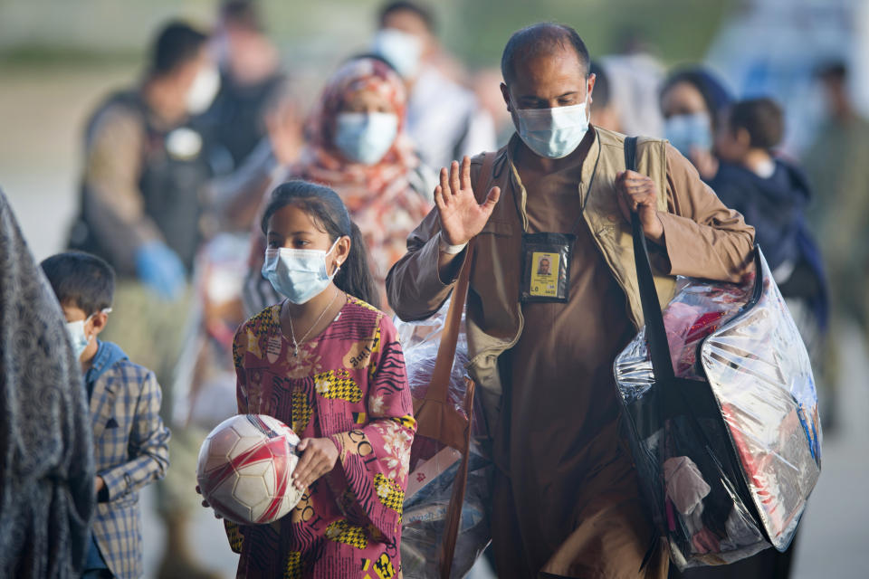 Evacuees from Afghanistan arrive after disembarking from a U.S. airforce plane at the Naval Station in Rota, southern Spain, Tuesday Aug. 31, 2021. The United States completed its withdrawal from Afghanistan late Monday, ending America's longest war. (AP Photo/ Marcos Moreno)