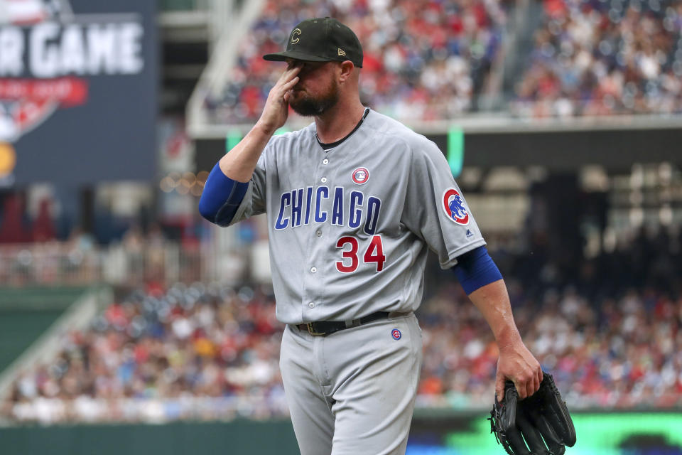 Chicago Cubs starting pitcher Jon Lester wipes his face as he walks off the field at the end of the second inning of the team's baseball game against the Washington Nationals, Saturday, May 18, 2019, in Washington. (AP Photo/Andrew Harnik)