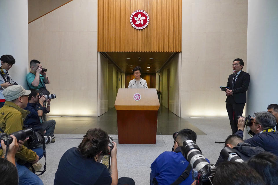 Hong Kong Chief Executive Carrie Lam, center, speaks during a press conference in Hong Kong, Tuesday, Nov. 26, 2019. Lam has refused to offer any concessions to anti-government protesters after a local election setback. (AP Photo/Vincent Yu)