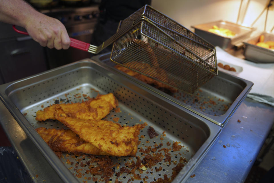 Fried fish is prepared at the Swissvale Fire Department fish fry in Pittsburgh, on Friday, Feb. 24, 2023. Fish fries have been a longtime Catholic tradition in Western Pennsylvania but increased in popularity in 1966 after the Second Vatican Council announced that not eating meat on Fridays was optional, except during Lent. Today they are held anywhere, from churches to fire stations to restaurants. (AP Photo/Jessie Wardarski)