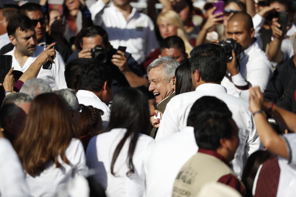 Mexican President Andres Manuel Lopez Obrador, center, arrives at a rally in Tijuana, Mexico, Saturday, June 8, 2019. The event was originally scheduled as an act of solidarity in the face of President Donald Trump's threat to impose a 5% tariff on Mexican imports if it did not stem the flow of Central American migrants heading toward the U.S. But Mexican and U.S. officials reached an accord Friday that calls on Mexico to crackdown on migrants in exchange for Trump backing off his threat. (AP Photo/Eduardo Verdugo)