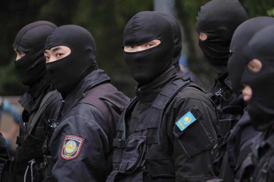 Kazakh police block demonstrators in Almaty, Kazakhstan, Wednesday, June 12, 2019, during protests against presidential elections. Protests have continued in the capital, Nur-Sultan, and in Almaty, Kazakhstan's principal city. Police detained 35 people Wednesday in Almaty as they gathered with plans to hold protests, the Interfax news agency reported. (AP Photo/Vladimir Tretyakov)