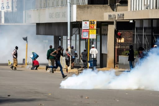 Protesters rushed for cover as police fired tear gas