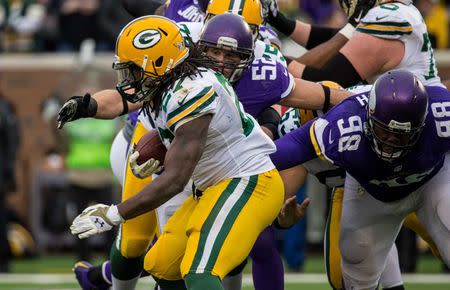 Nov 23, 2014; Minneapolis, MN, USA; Green Bay Packers running back Eddie Lacy (27) is tackled by Minnesota Vikings linebacker Chad Greenway (52) and defensive tackle Linval Joseph (98) during the third quarter at TCF Bank Stadium. The Packers defeated the Vikings 24-21. Mandatory Credit: Brace Hemmelgarn-USA TODAY Sports