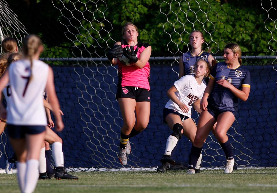 DeWitt goalkeeper Madison McDonald, center, stops a Mason shot, Thursday, June 1, 2023, in DeWitt.