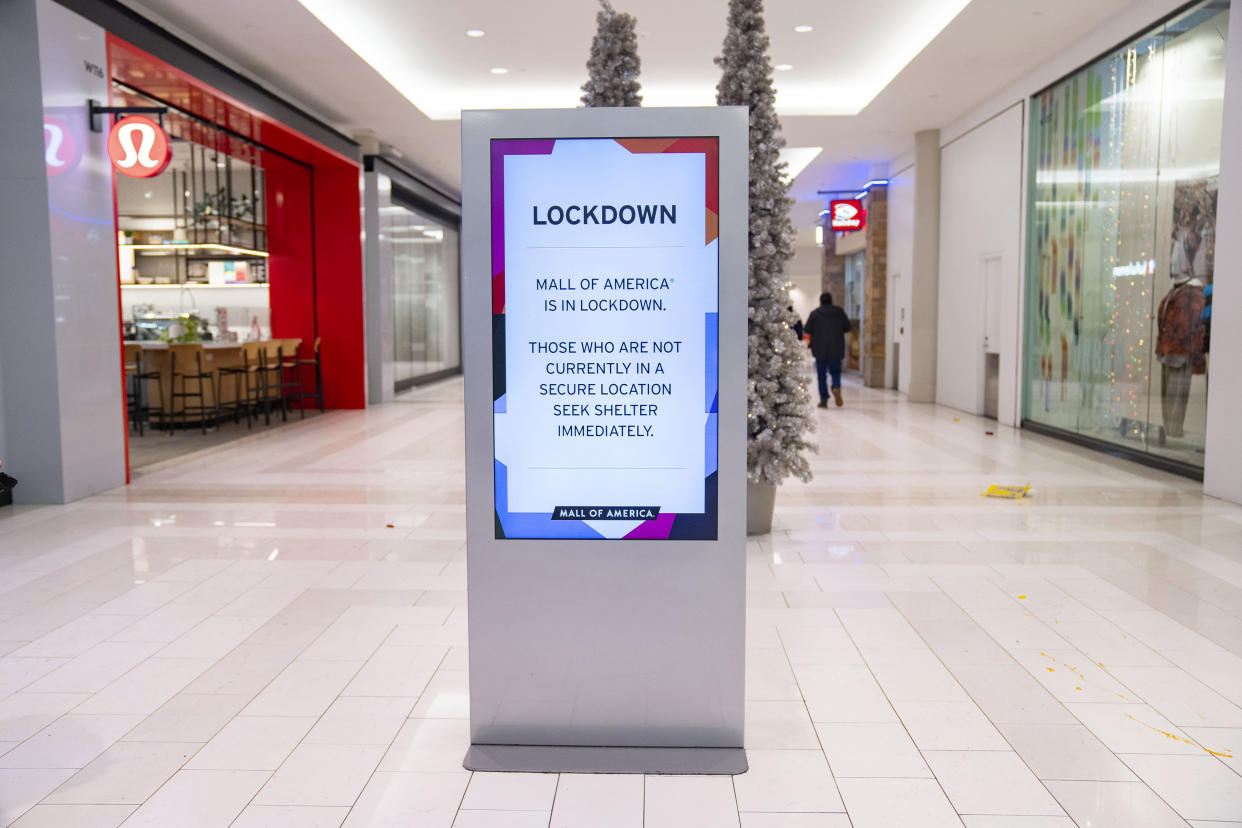 Signs around the Mall of America indicate that a lockdown is in progress after a shooting was reported Friday, Dec. 23, 2022 in Bloomington, Minn. A shooting sent the Mall of America into lockdown Friday evening, mall officials and police in suburban Minneapolis said. (Alex Kormann/Star Tribune via AP)