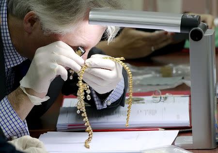 David Warren, a member of Christie's, appraises jewelry of former first ady Imelda Marcos during the Presidential Commission on Good Government (PCGG) appraisal of the confiscated jewelry collection from the Marcos family inside the Central Bank headquarter in Manila November 24, 2015. REUTERS/Romeo Ranoco