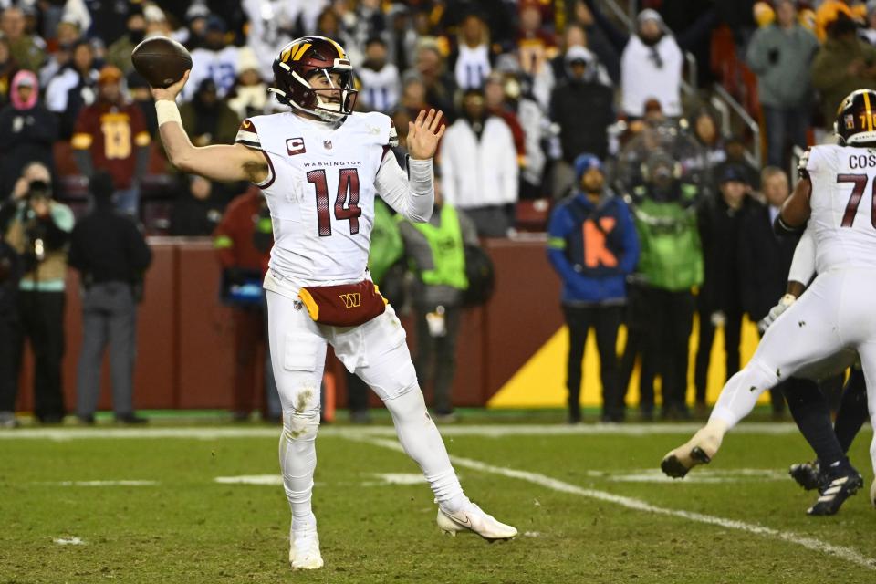 Jan 7, 2024; Landover, Maryland, USA; Washington Commanders quarterback Sam Howell (14) attempts a pass against the Dallas Cowboys during the second half at FedExField. Mandatory Credit: Brad Mills-USA TODAY Sports