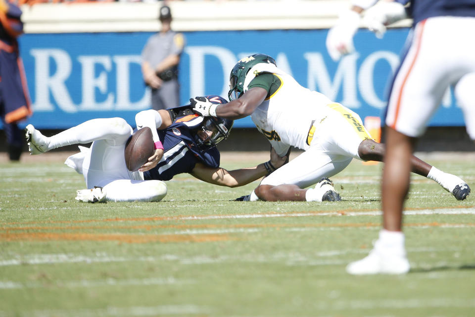 Oct 7, 2023; Charlottesville, Virginia, USA; Virginia Cavaliers quarterback Tony Muskett (11) is sacked by William & Mary Tribe linebacker John Pius (8) during the first half at Scott Stadium. Mandatory Credit: Amber Searls-USA TODAY Sports