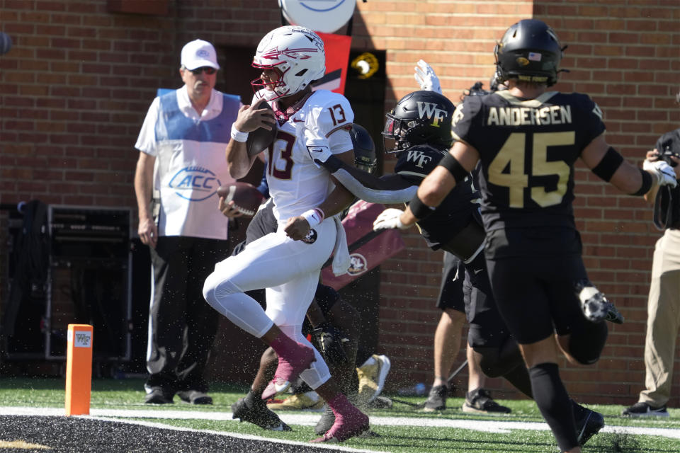 Florida State quarterback Jordan Travis (13) runs for a touchdown against Wake Forest during the first half of an NCAA college football game in Winston-Salem, N.C., Saturday, Oct. 28, 2023. (AP Photo/Chuck Burton)