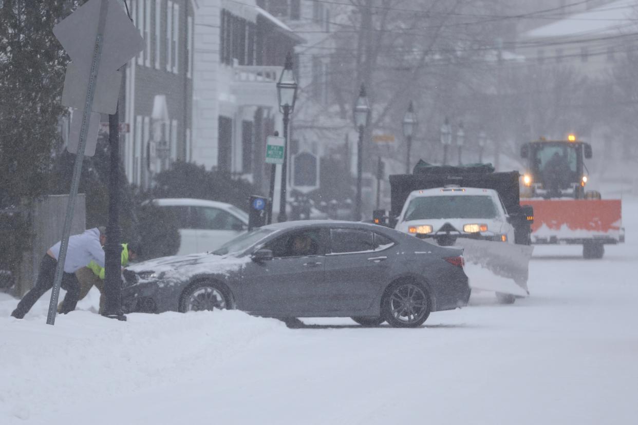 A driver needs a push on Court Street in Portsmouth during the snow storm Friday, Feb. 25, 2022.