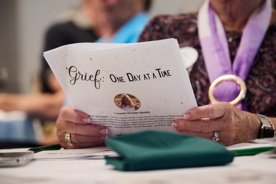 A guest at a Family Wealth Group conference focused on handling grief holds death doula Lauren Hunter-Smith’s program on Aug. 11, 2023, at the Marriott Griffen Gate in Lexington, Kentucky. The Family Wealth Group is a financial planning and advising firm primarily focused on financial plans for retirees. Hunter-Smith’s presentation centered on what her services as a death doula can provide those planning burials or death ceremonies.