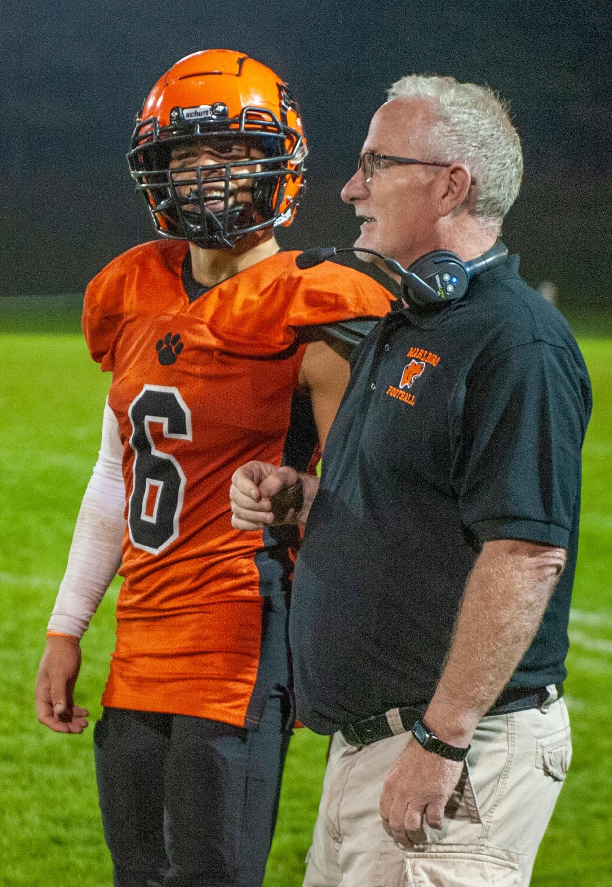 Marlborough High School captain and senior quarterback Miguel Borges with Head Coach Sean Mahoney as the clock ticked down in the fourth quarter against Fitchburg at Kelleher Field, Oct. 6, 2023.