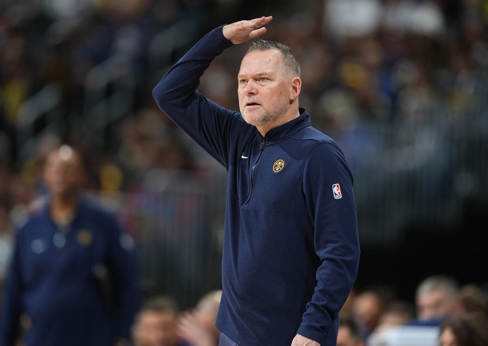 Denver Nuggets coach Michael Malone gestures for a call during the second half of the team's NBA basketball game against the New Orleans Pelicans on Friday, Jan. 12, 2024, in Denver. (AP Photo/David Zalubowski)