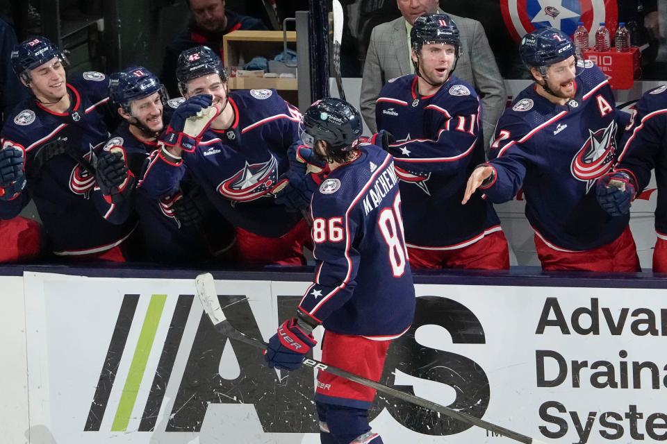 Jan 15, 2024; Columbus, Ohio, USA; Columbus Blue Jackets right wing Kirill Marchenko (86) gets high fives from the bench after scoring a goal during the shootout in the NHL hockey game against the Vancouver Canucks at Nationwide Arena. The Blue Jackets won 4-3 in a shootout.