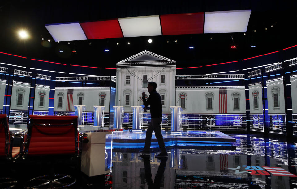 A person walks across the stage during setup for the Nevada Democratic presidential debate Tuesday, Feb. 18, 2020, in Las Vegas. (AP Photo/John Locher)