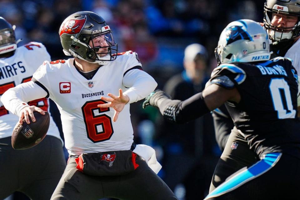 Tampa Bay Buccaneers quarterback Baker Mayfield (6) works in the pocket as Carolina Panthers linebacker Brian Burns (0) defends during the first half of an NFL football game, Sunday, Jan. 7, 2024, in Charlotte, N.C. (AP Photo/Rusty Jones)