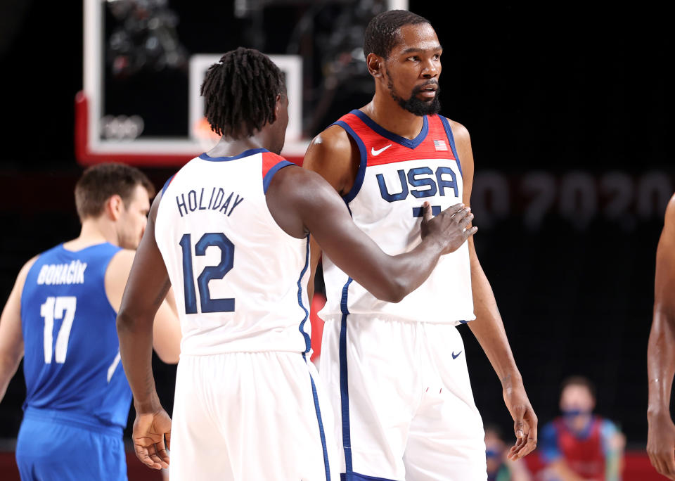 Jrue Holiday (left) pats teammate Kevin Durant on the chest during the first half of their game against Czech Republic at the Tokyo 2020 Olympic Games on July 31. (Gregory Shamus/Getty Images)