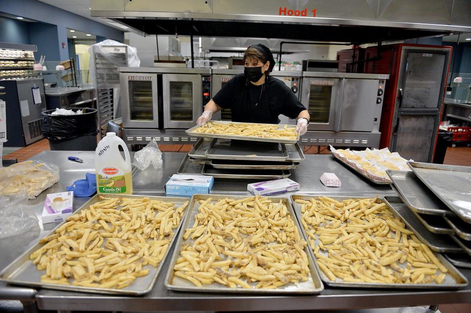 Carol DeMeo, a cafeteria worker at Assabet Valley Regional Technical High School, prepares French fries for the approximately 950 students that eat school meals.