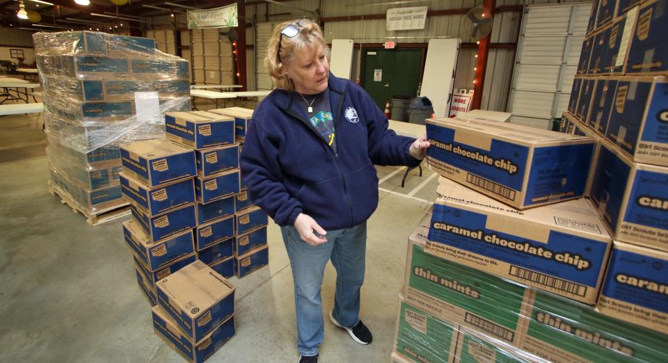 Janet Crawford checks for any damaged boxes as 1,500 cases of Girl Scout cookies were unloaded early Friday morning, Jan. 12, 2024, at the Gastonia Farmers Market on East Long Avenue.