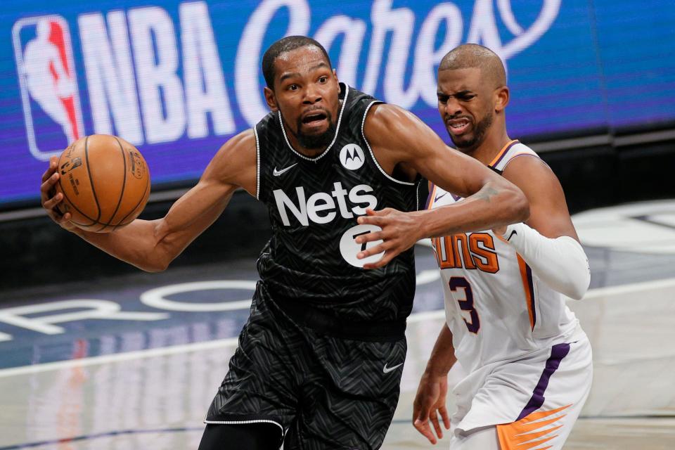 Kevin Durant, left, and Chris Paul now are teammates in Phoenix.